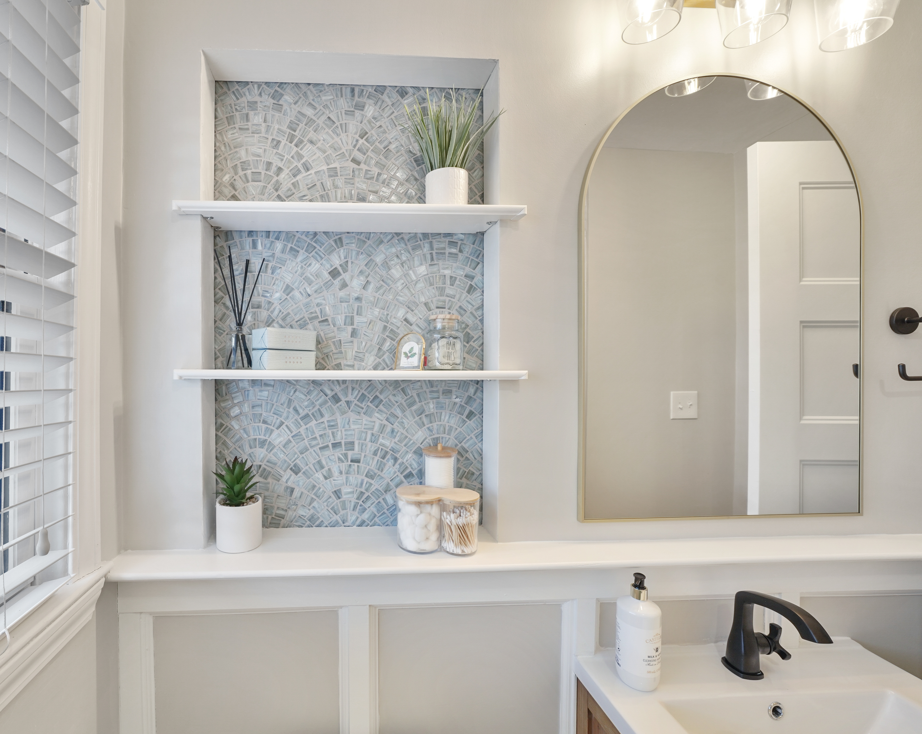 Elegant bathroom with mosaic tile feature wall